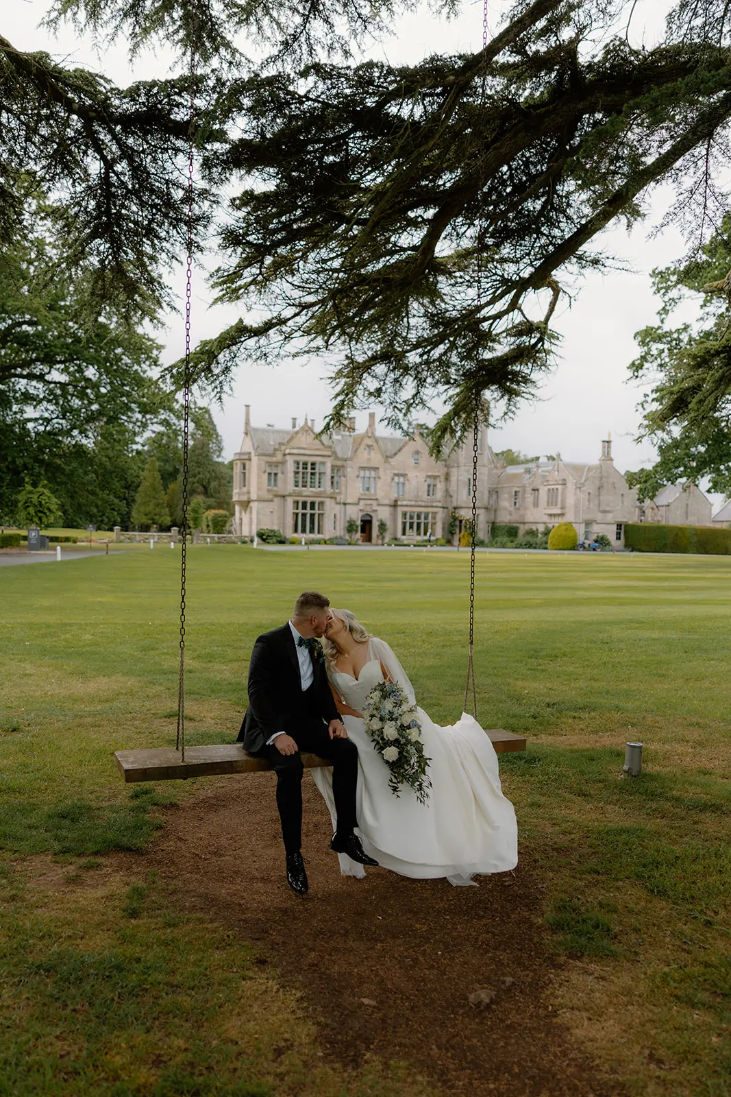 Newlyweds on the swing at SCHLOSS Roxburghe